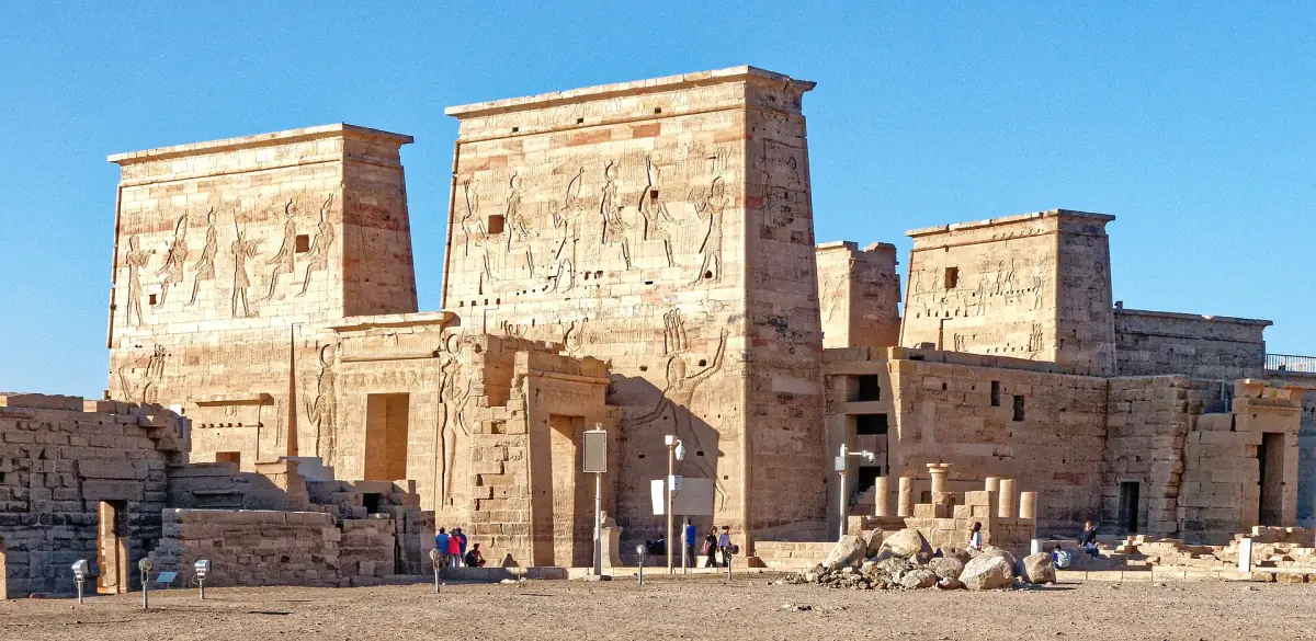 Philae Temple first pylon with carved reliefs under a clear blue sky