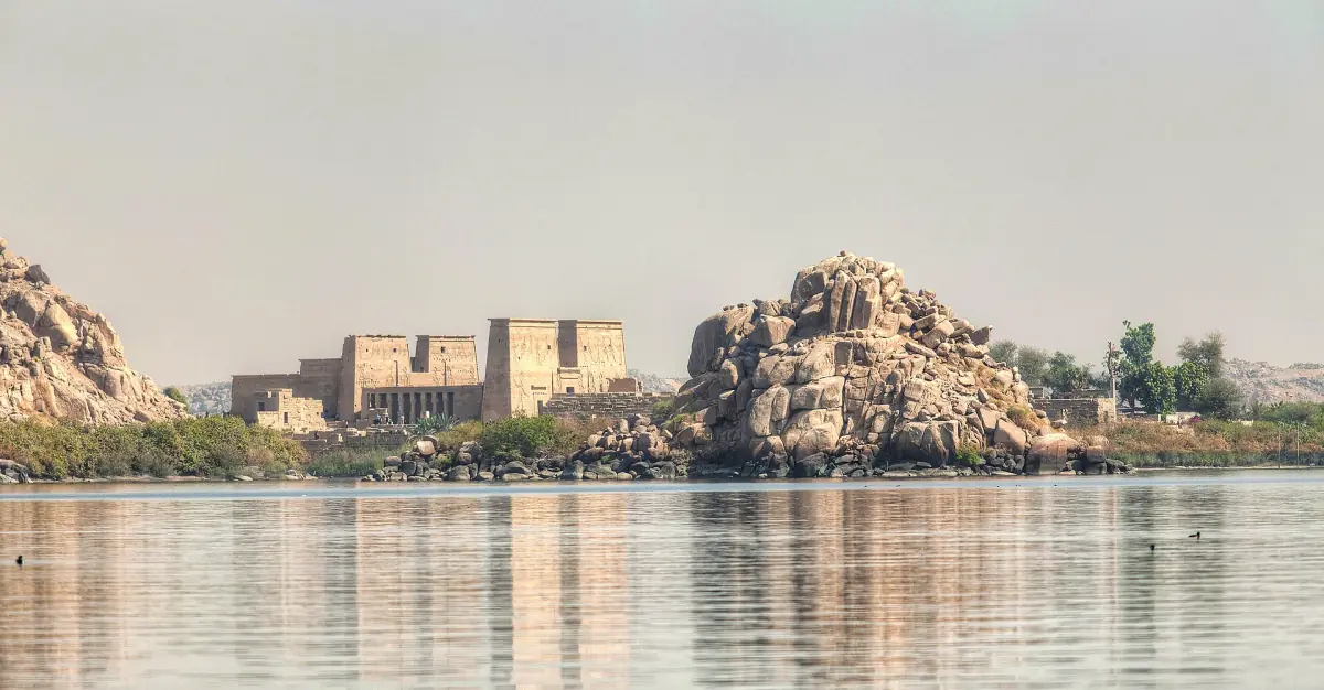 Philae temple on its island reflected in calm water
