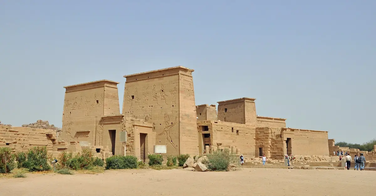 Pylons of the Temple of Isis seen across sandy ground